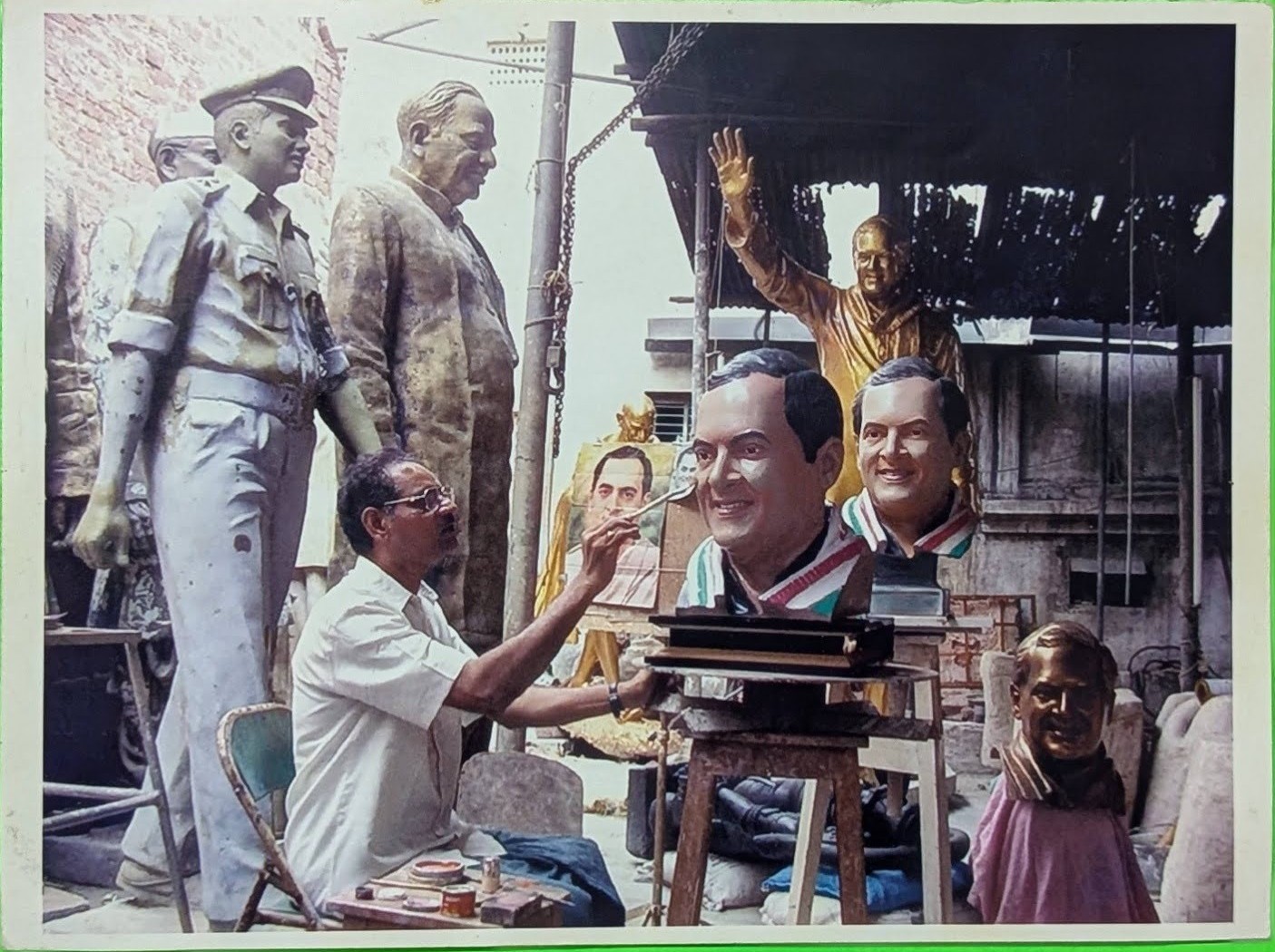 Sri Akkala Ramakrishna Rao at work in his studio, sculpting clay busts of prominent leaders including Rajiv Gandhi.